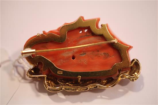 A Chinese 14ct gold mounted carved coral brooch, modelled as a masted ship at sea, 2.25in.